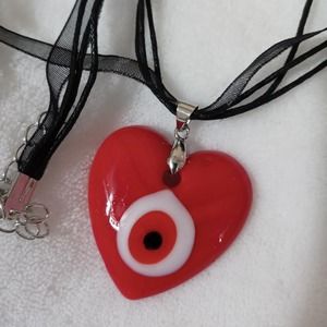 Red glass heart evil eye
